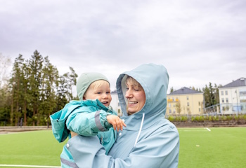 Nainen lapsi sylissään.