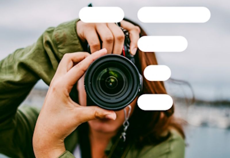 A woman holding a camera.