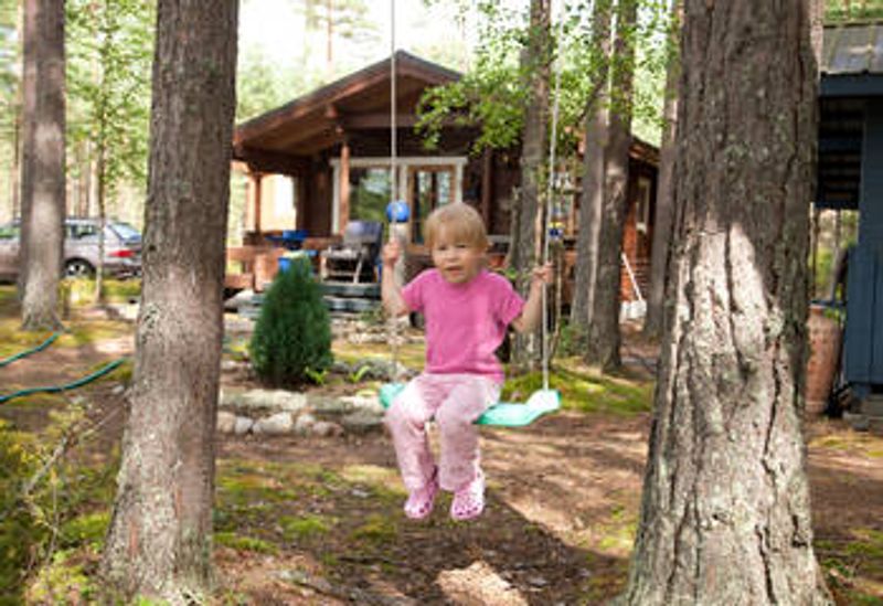 A child in the yard of a summer cottage